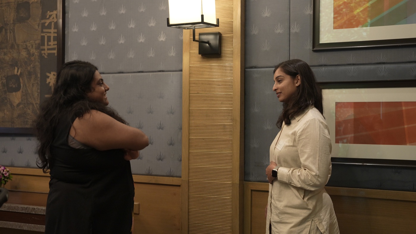 Two participants standing in conversation during a break.