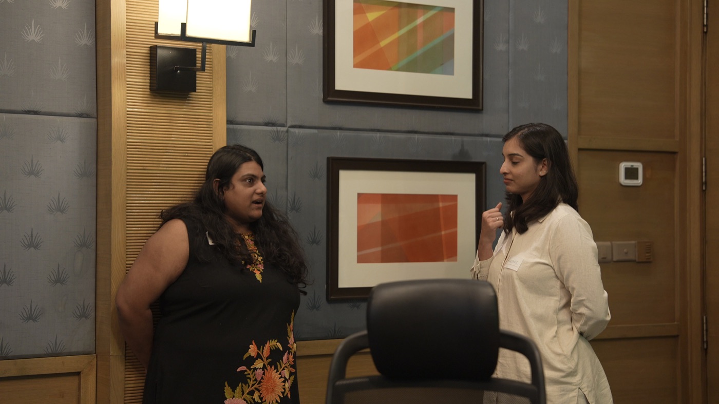 Two participants standing in conversation.