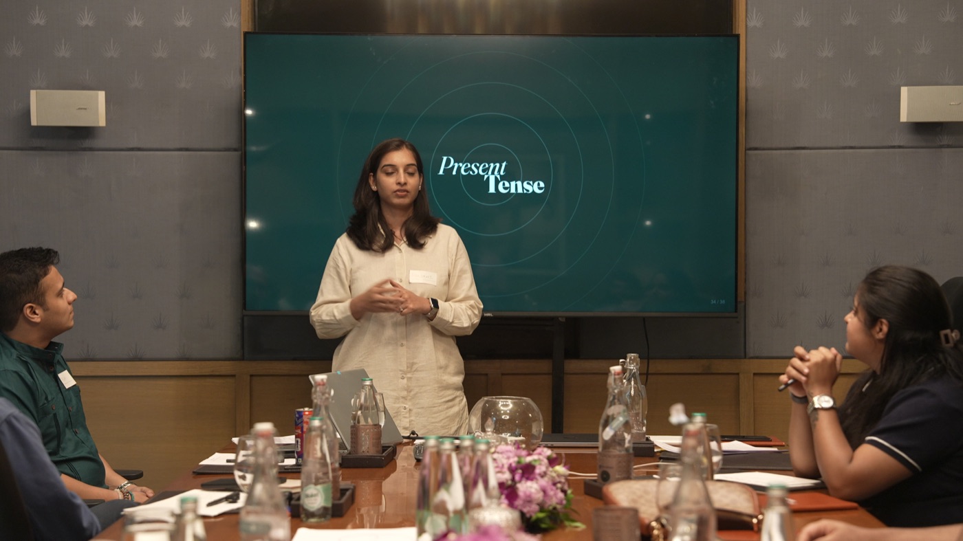 A participant standing to speak at the Present Tense screen.