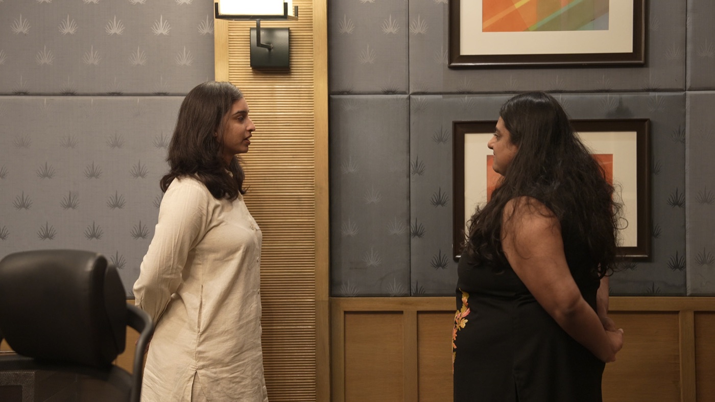 Two participants standing in conversation.