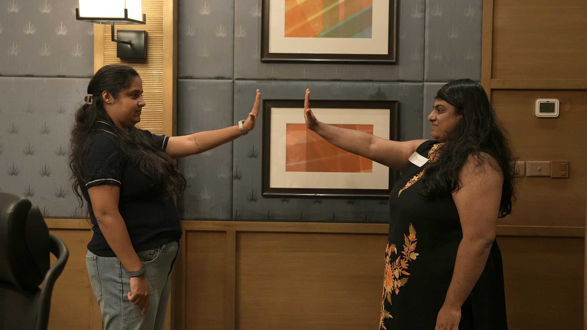 Two participants mirroring each other, palms raised.