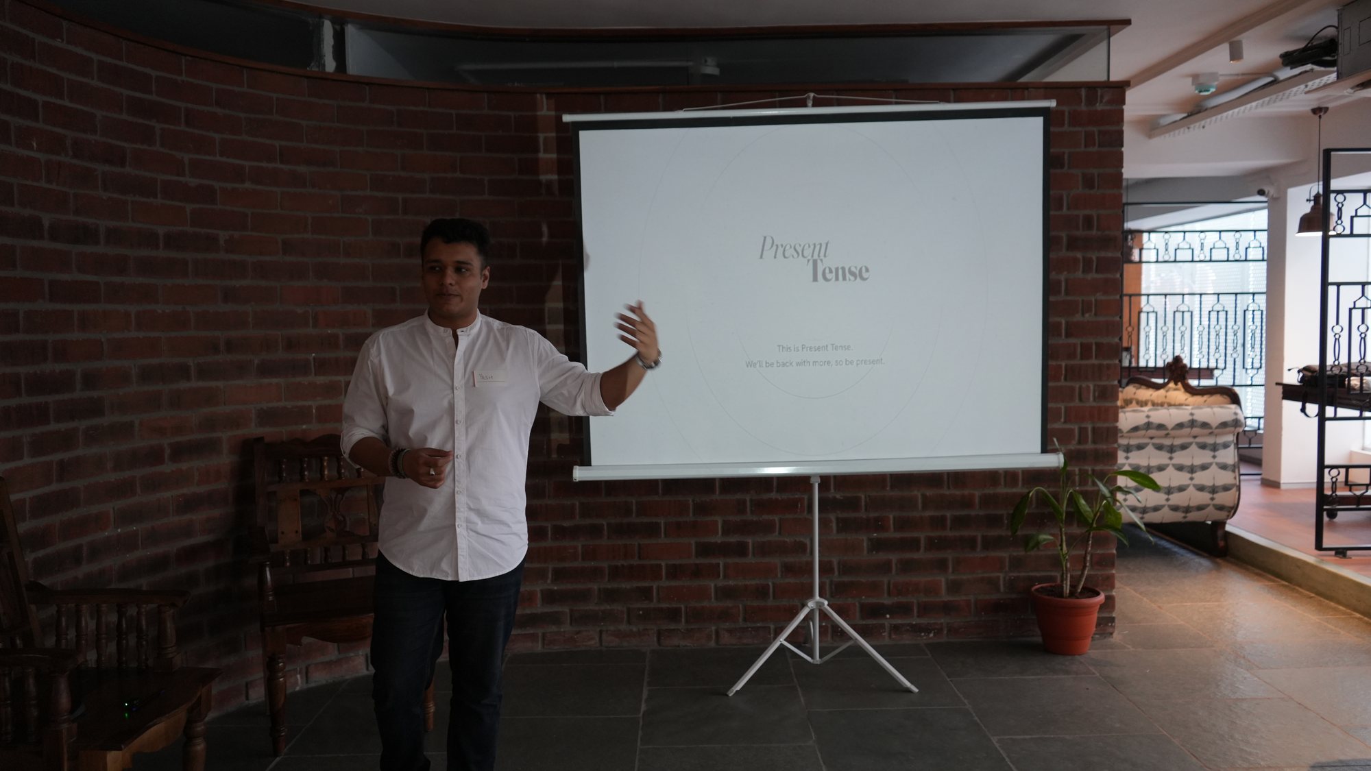 Yash talking the room through the next exercise at the Present Tense screen.