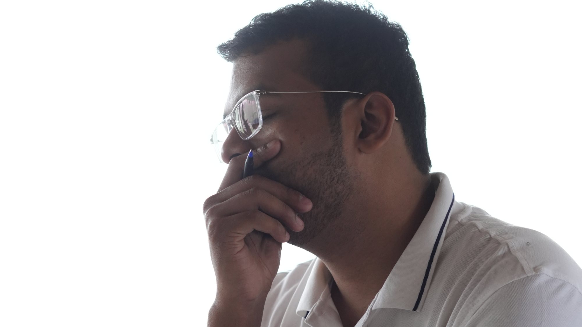 A participant deep in thought, hand to his chin.